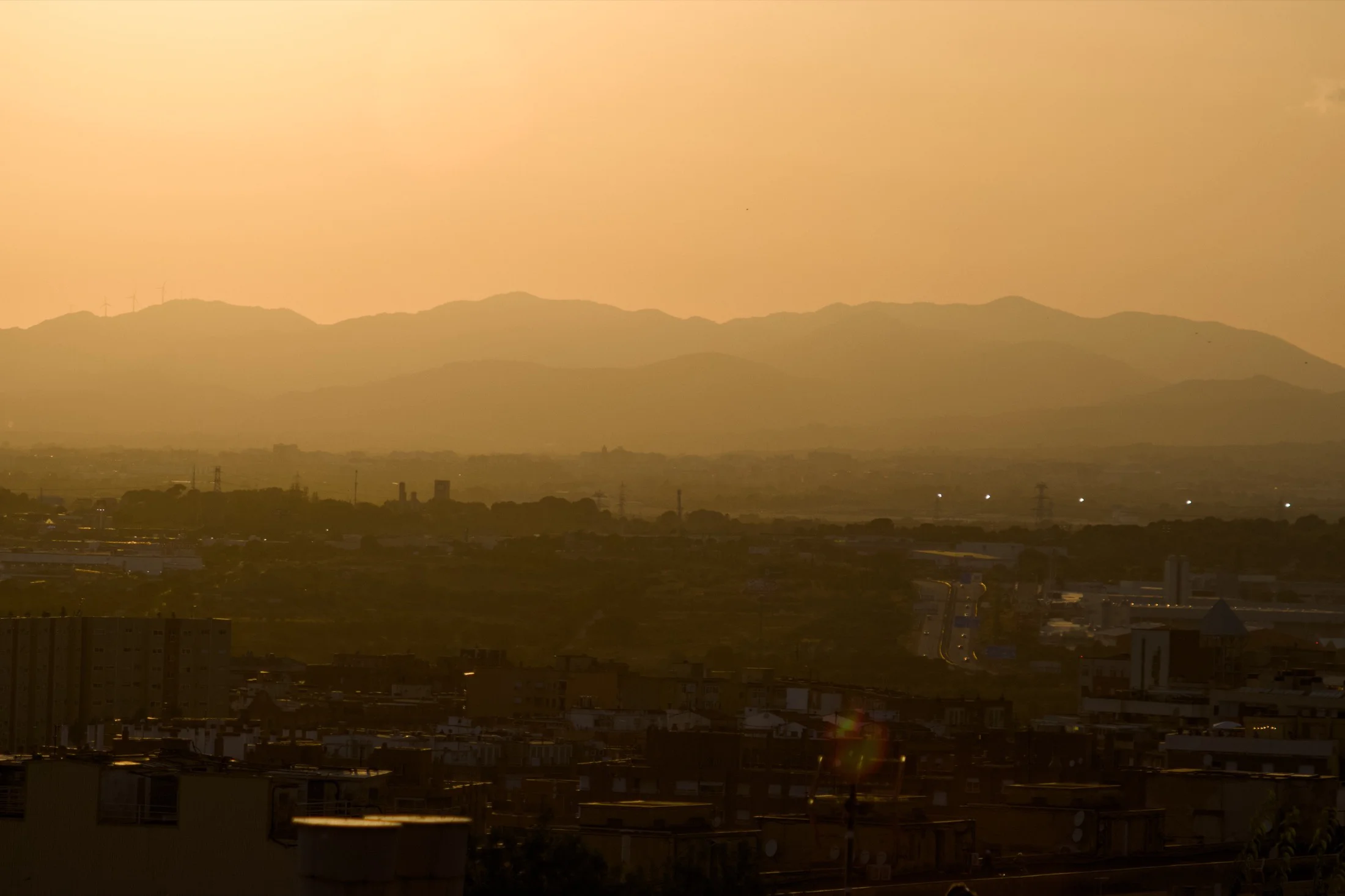 warm light of the eclipse over Tarragona rooftops