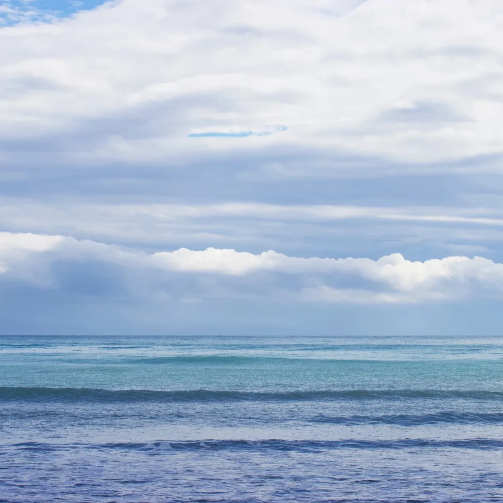 gradient of blue waves and cludy sky