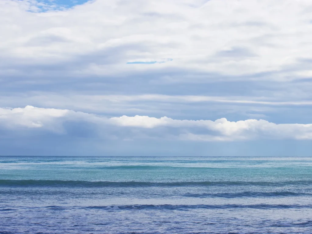 gradient of blue waves and cludy sky