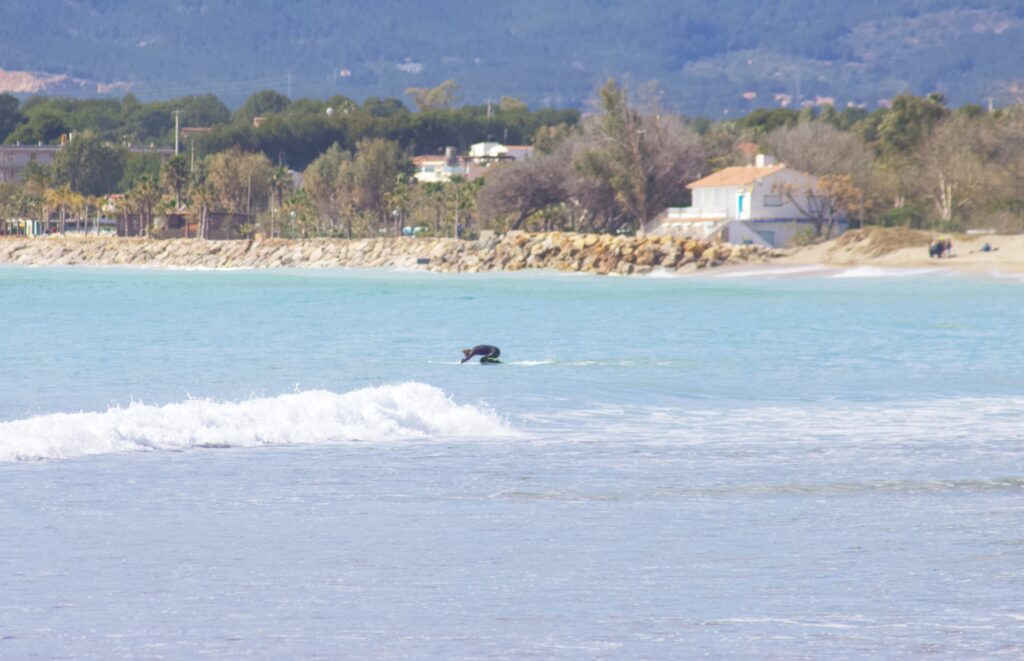 surfer paddling on her knees