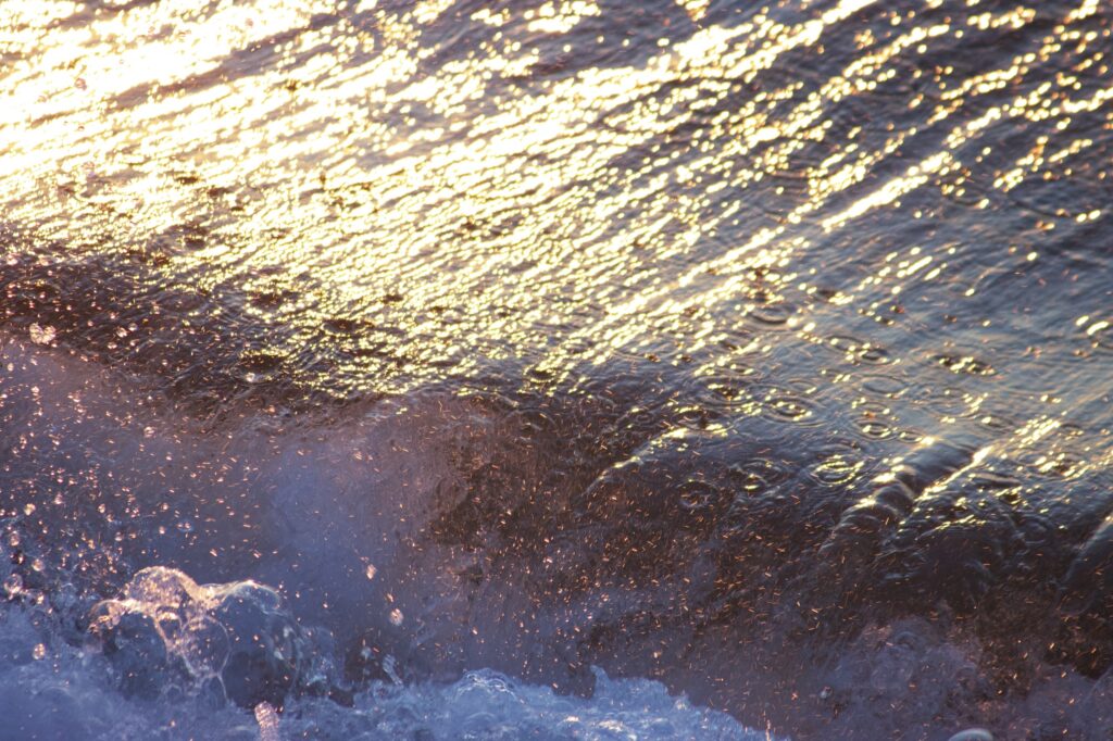 sun reflected in broken wave